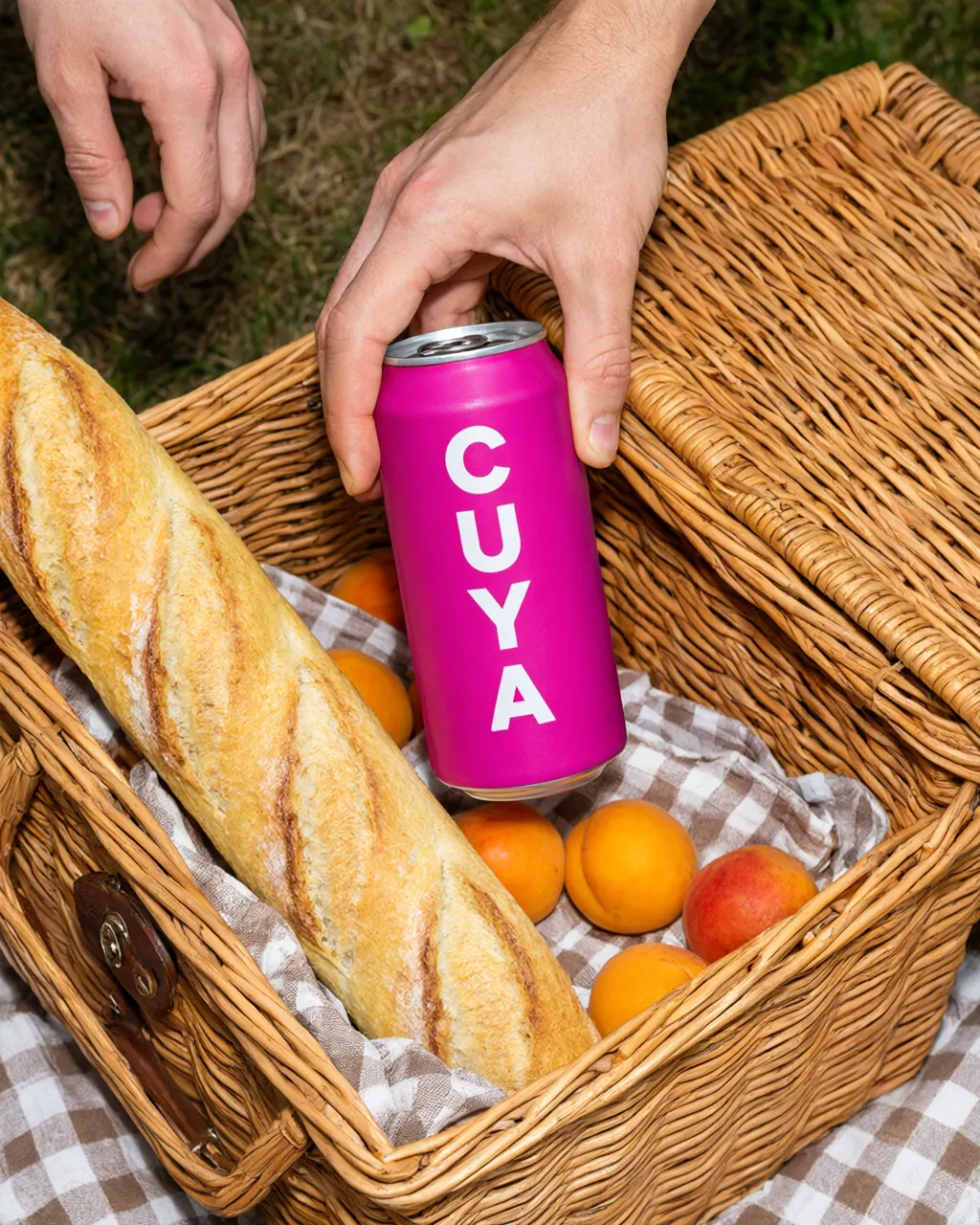 A pink Cuya can slipped into a picnic basket